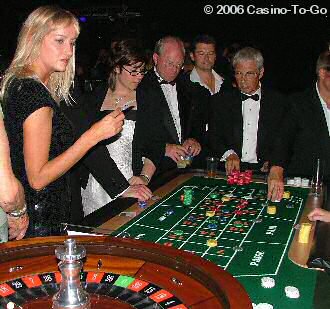 Roulette table with guests in fromal dress